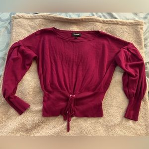 Express pink long sleeved top with tie at bottom and puff sleeves